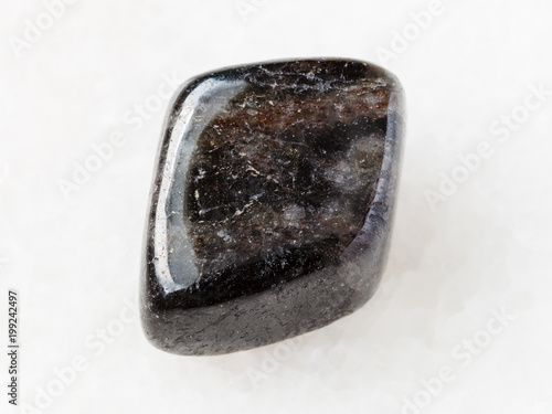 tumbled anthophyllite gemstone on white photo