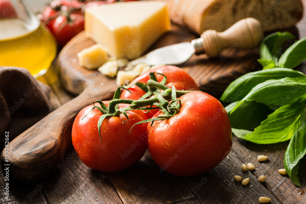 Tomatoes on vine, olive oil and parmesan cheese. Italian food background or still life Tomatoes on vine, olive oil and parmesan cheese. Italian food background or still life