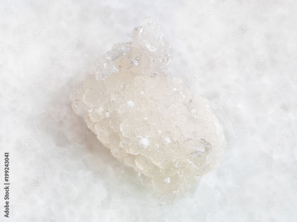 rough crystal of Prehnite with Okenite on white rough crystal of Prehnite with Okenite on white