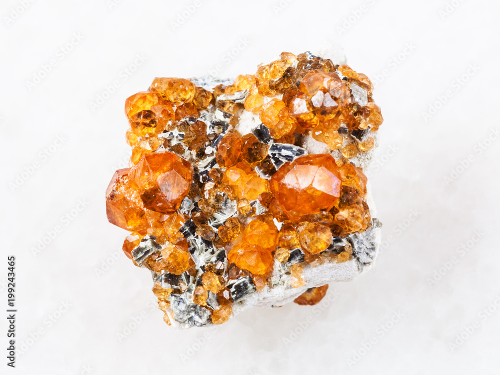 crystals of spessartine garnet gemstone on white crystals of spessartine garnet gemstone on white