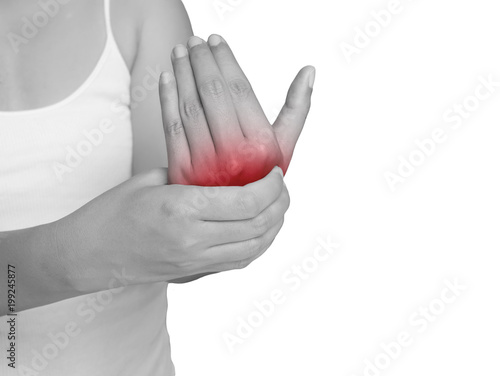 woman suffering from pain in hand. mono tone highlight at hand isolated on white background. health care and medical concept © asiandelight