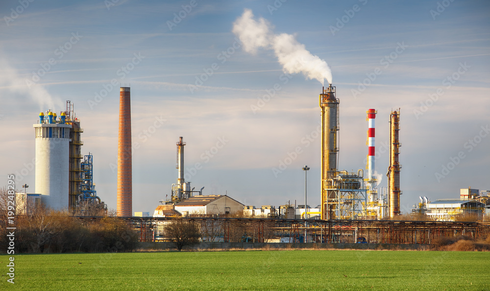 Smoking chimneys of a petrochemical factory in an oil refinery