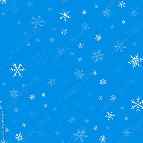 Light blue snowflakes seamless pattern on blue Christmas background. Chaotic scattered light blue snowflakes. Wonderful Christmas creative pattern. Vector illustration.
