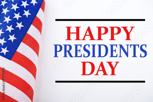 Background of United States flag on white background next to text about Hapy presidents day celebration.