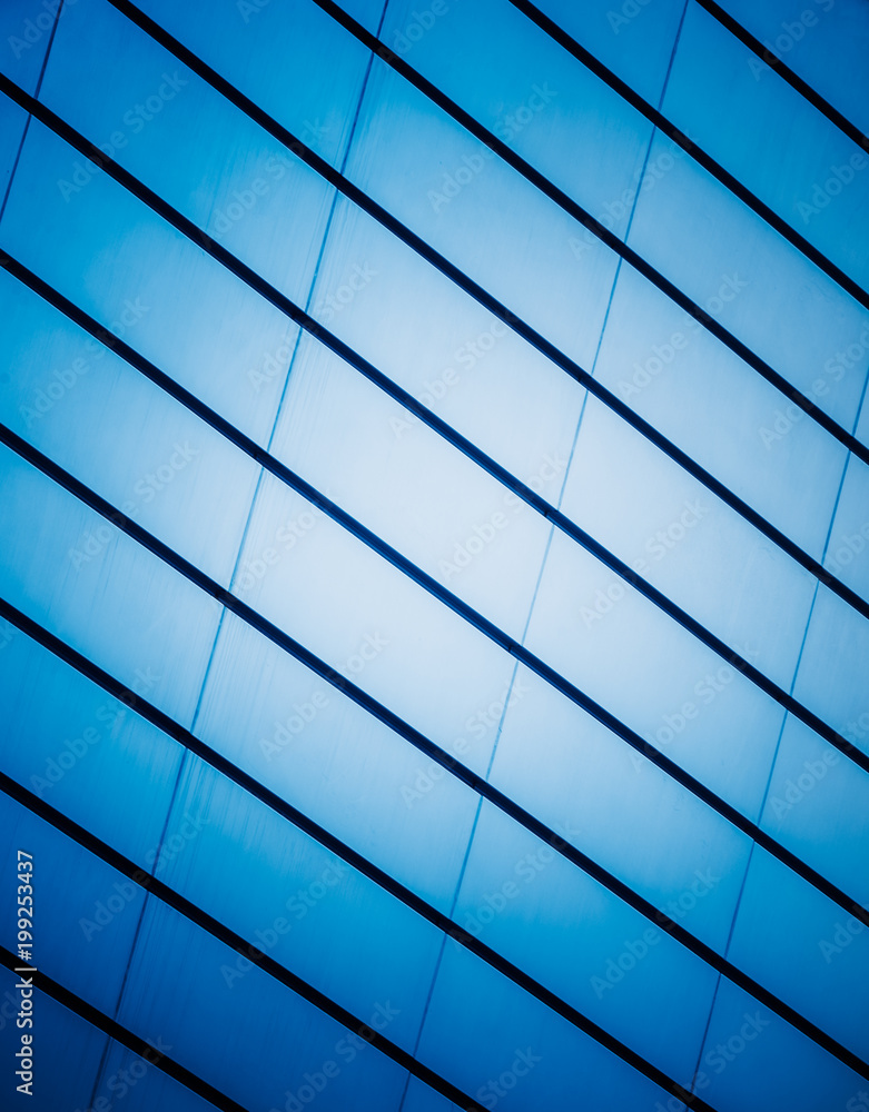 Fototapeta premium full frame of modern glass building,blue toned.