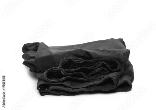Folded pair of black sports, trekking pants isolated on white background