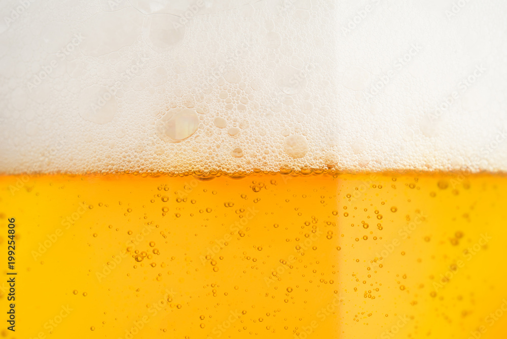 Pouring beer with bubble froth in glass for background on front view Pouring beer with bubble froth in glass for background on front view