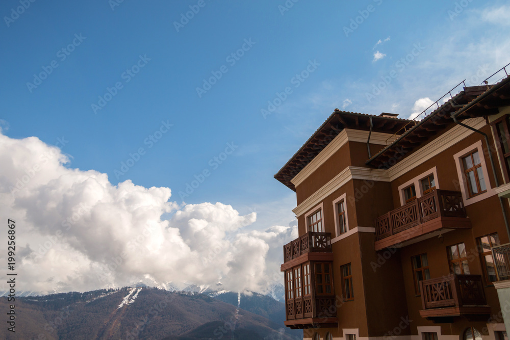 Modern beautiful house on the background of mountains.
