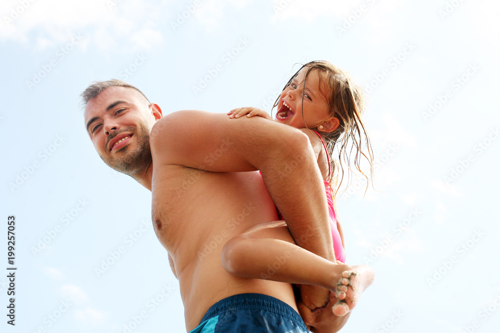 Father and daughter having fun together on the beach. Father and daughter having fun together on the beach.