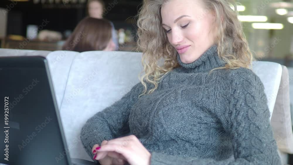 Close-up . of young girl using laptop computer for remote work on window background, technology and social network concept, woman hands typing on laptop keyboard, 4k, blur background. Close-up . of young girl using laptop computer for remote work on window background, technology and social network concept, woman hands typing on laptop keyboard, 4k, blur background.