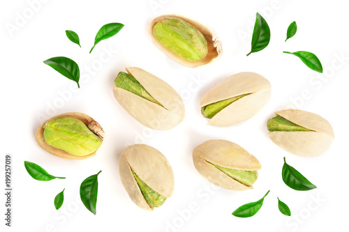 Pistachios decorated with green leaves isolated on white background, top view. Flat lay photo