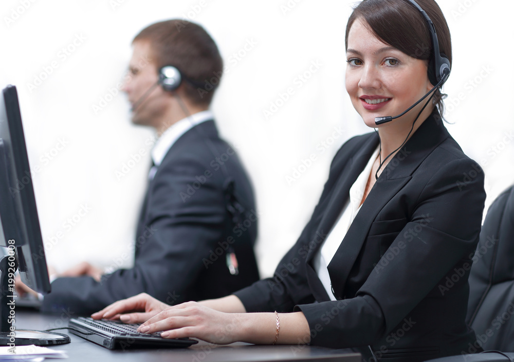 Female Customer Services Agent With Headset Working In A Call Center Female Customer Services Agent With Headset Working In A Call Center