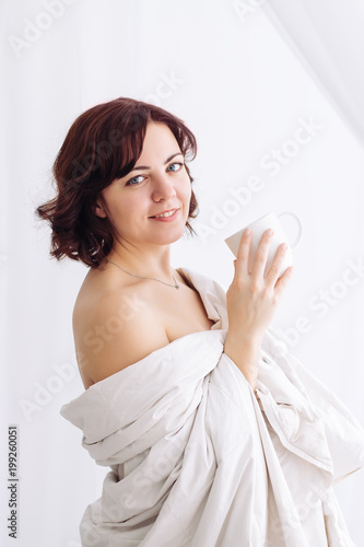 portrait Caucasian girl blanket bare shoulders coffee photo