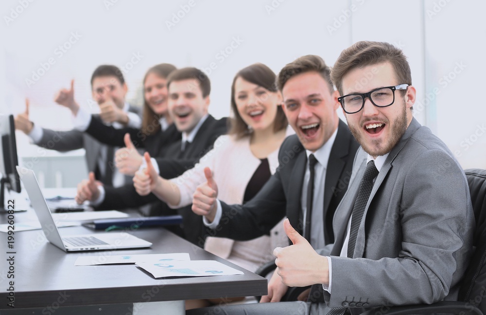 business team with thumbs up while sitting at his Desk business team with thumbs up while sitting at his Desk