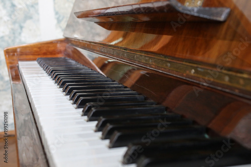 Black and white piano keys in perspective background. Old wooden musical instrument. Creative musician photo.