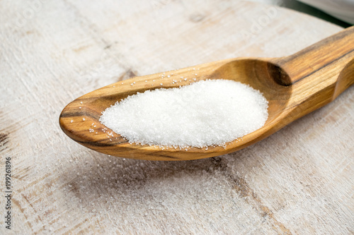 Artificial Sweeteners and Sugar Substitutes in wooden spoon. Natural and synthetic sugarfree food additive:  sorbitol, fructose, honey, Sucralose, Aspartame photo