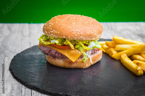 Hamburger with fries on blackboard