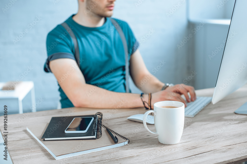close-up view of smartphone, notebooks and cup of coffee, freelancer working behind close-up view of smartphone, notebooks and cup of coffee, freelancer working behind