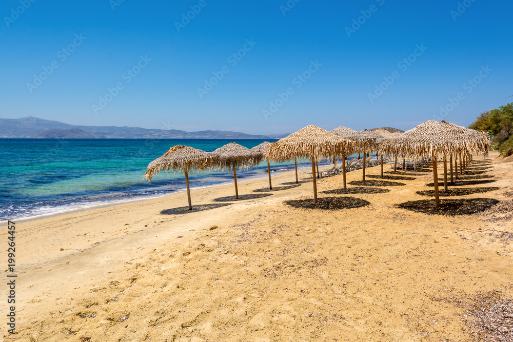 Parasols on Agia Anna beach, one of the best organized beaches of Naxos. Cyclades Islands, Greece. Parasols on Agia Anna beach, one of the best organized beaches of Naxos. Cyclades Islands, Greece.