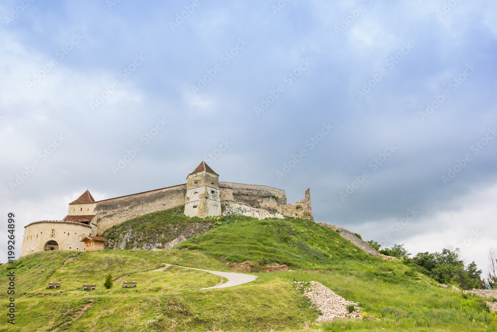 Castle on top of a green hill near Rasnov, Romania