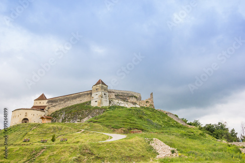 Castle on top of a green hill near Rasnov, Romania