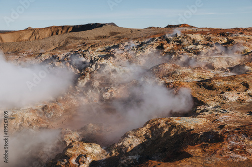 beautiful icelandic landscape with steam from hot springs at sunny day, Gunnuhver Hot Springs, reykjanes, iceland