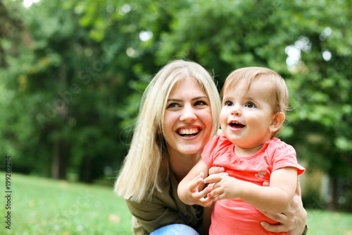 Baby girl and mother enjoying outdoor.