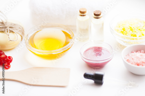 Natural herbal skin care products. Top view ingredients honey, sea salt, berries, oil and soap on the white background. Medical care, spa, beauty, health concept. 
