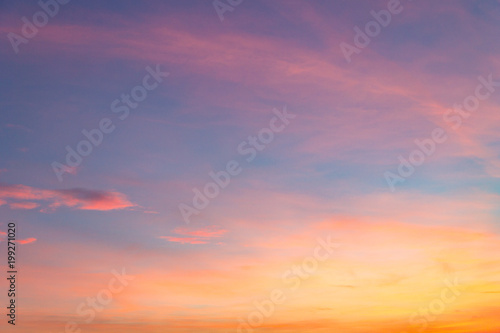 the sky at sunset with purple orange and blue hues. traces of aircraft and light clouds © Jevgenij