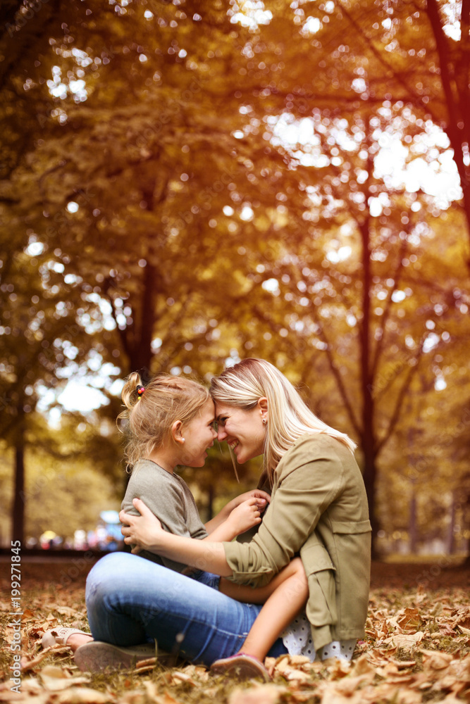 Cheerful mother with her daughter outdoor.