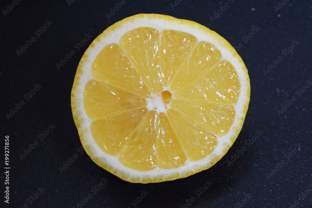 Fresh ripe lemons on dark stone background. Fresh ripe lemons on dark stone background.