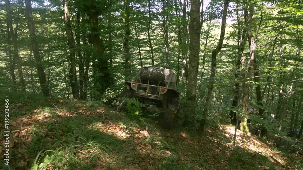 Offroad cars driving on a difficult track in the forest Offroad cars driving on a difficult track in the forest