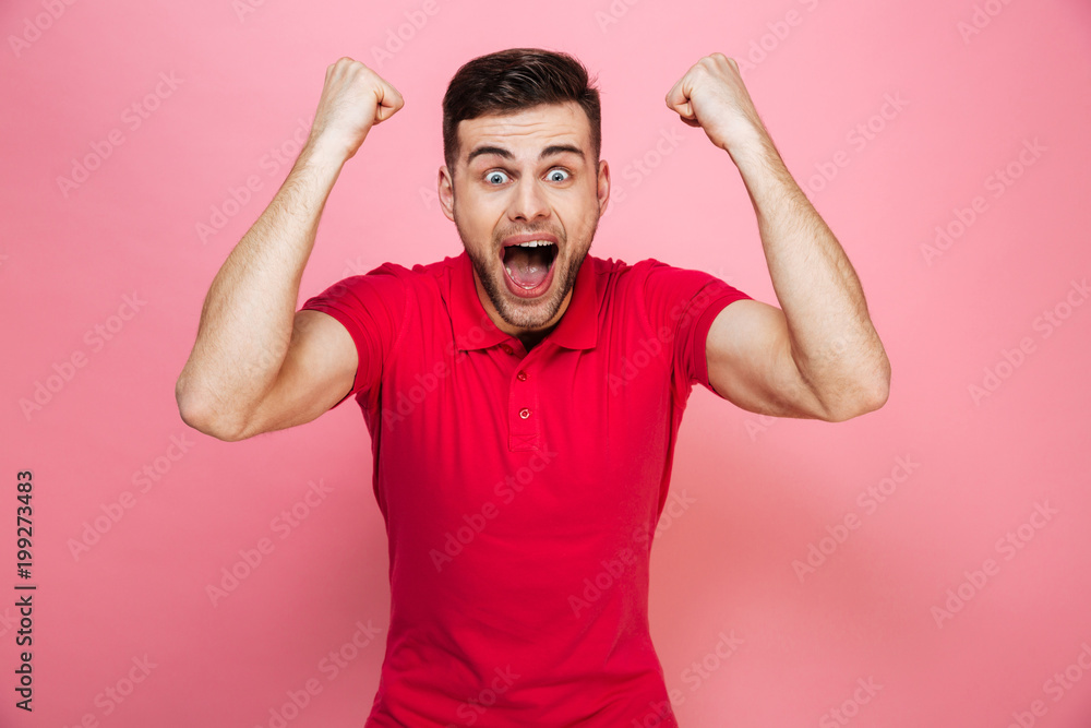 Fototapeta premium Portrait of a happy young man celebrating success