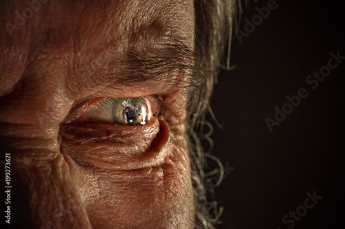 Half face of aggressive man looking with hatred into camera, domestic tyrant