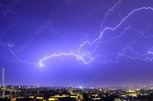 Lightning on a dark blue sky over the city.