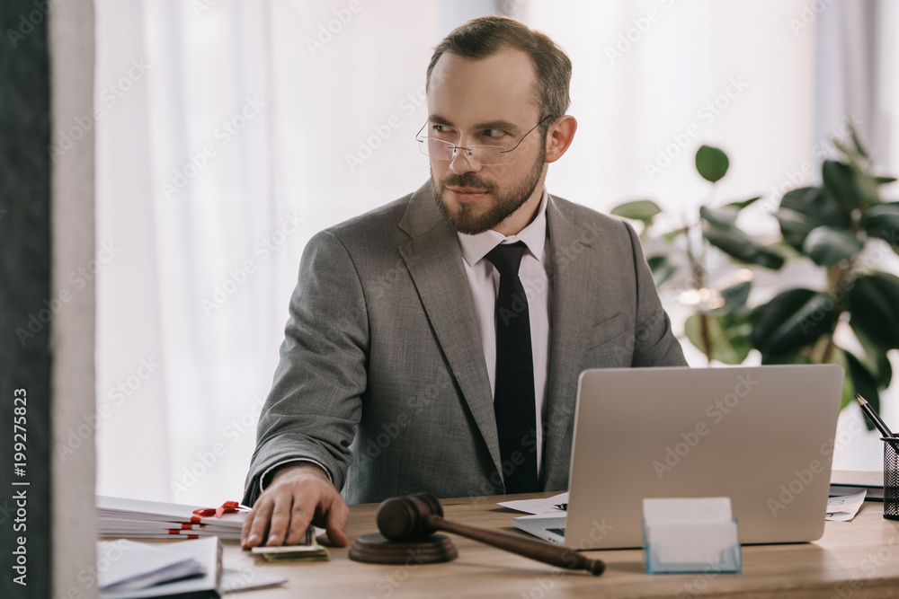 portrait of lawyer in eyeglasses taking bribe at workplace in office portrait of lawyer in eyeglasses taking bribe at workplace in office