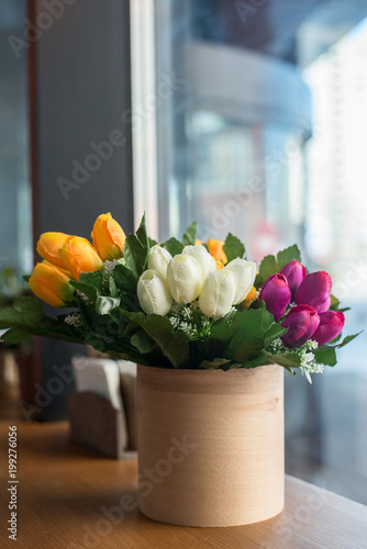  tulips in a vase by the window