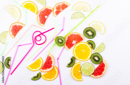 Colorful citrus slices and straws for coctail