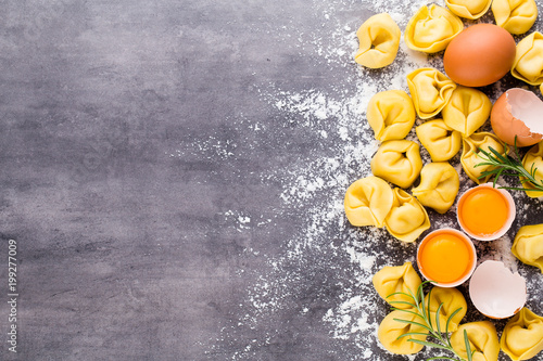 Homemade raw Italian tortellini and basil leaves.