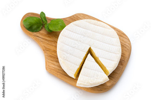 Piece of camembert cheese isolated on white background. From top view.