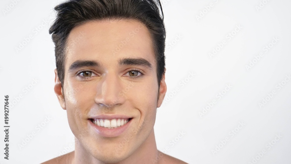 Close up of a man with moisturizer for his face smiling because he hydrates his skin and protects against impurities with anti-aging effects. Concept of: beauty and body care, creams, skincare Close up of a man with moisturizer for his face smiling because he hydrates his skin and protects against impurities with anti-aging effects. Concept of: beauty and body care, creams, skincare