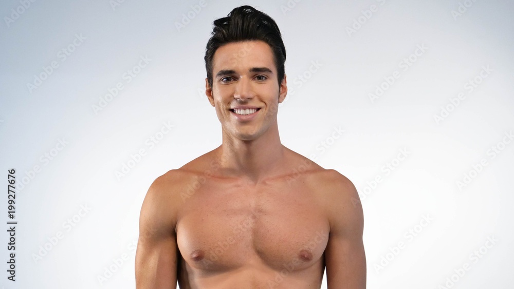 Fototapeta premium Close up of a man with moisturizer for his face smiling because he hydrates his skin and protects against impurities with anti-aging effects. Concept of: beauty and body care, creams, skincare