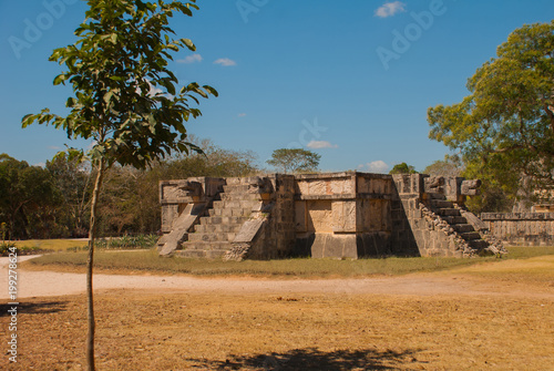 Stairs and Mayan sculpture on the corners. Ancient Mayan city. Chichen-Itza, Mexico. Yucatan photo