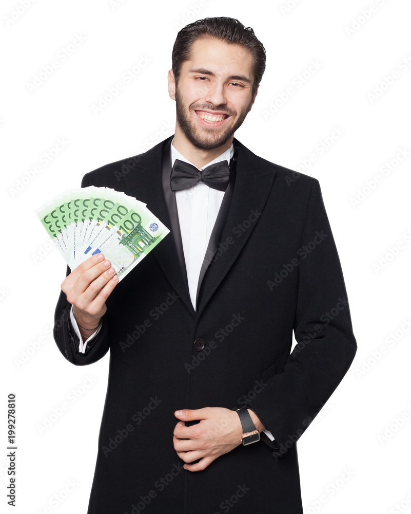 Shark of capitalism. Young male businessman is happy showing euro money. Dressed in a black suit with a bow tie and coat. Shark of capitalism. Young male businessman is happy showing euro money. Dressed in a black suit with a bow tie and coat.