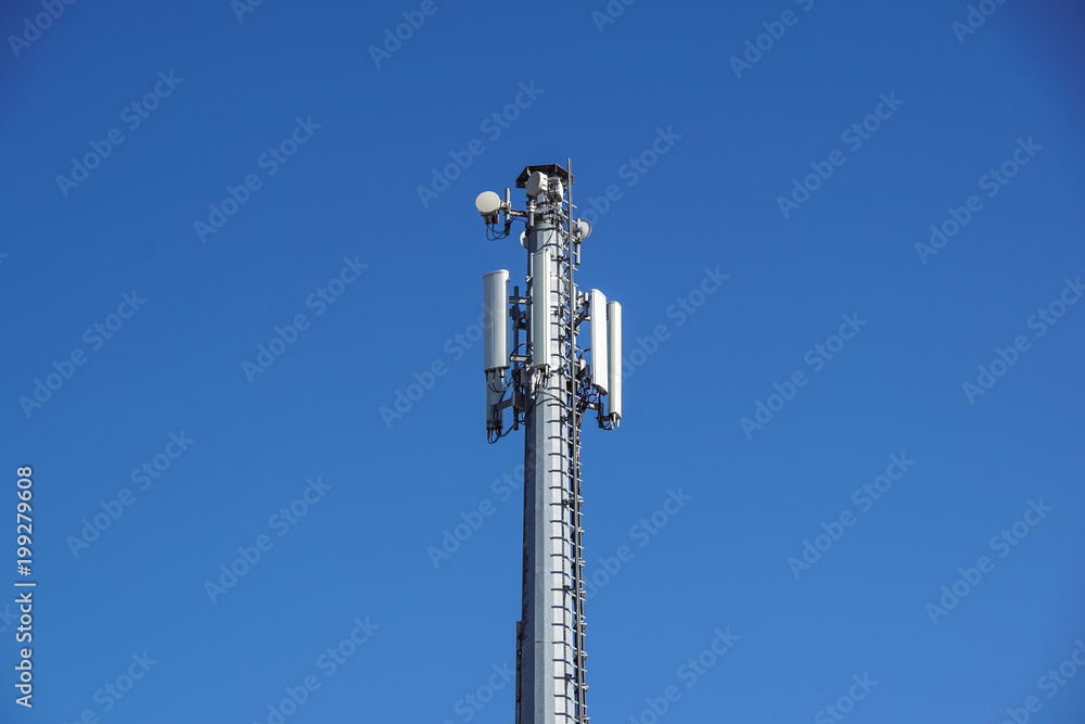 Technology on the top of the telecommunication GSM 4G tower antenna, transmitter , blue sky, white clouds.