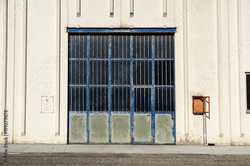 Cargo gate of Industrial warehouse. Industrial door. View on the one gates of big warehouse facade. Front view