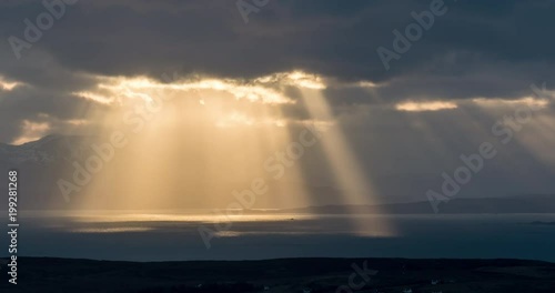 Timelapse clip of beautiful sun rays breaking through the clouds over the sea in Isle of Skye, Scotland.