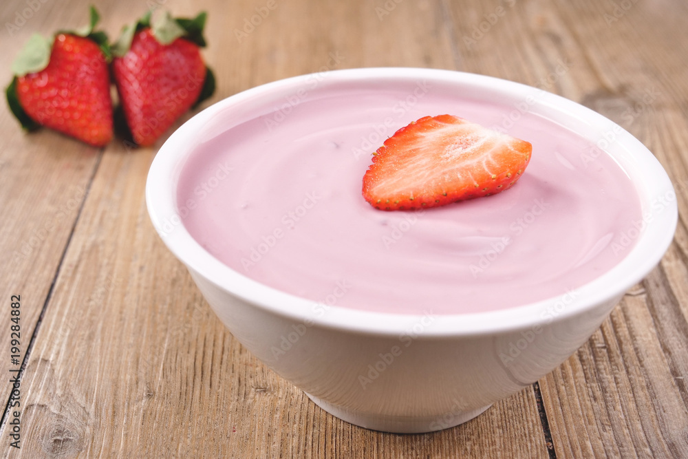 Composition of a typical genuine breakfast made with strawberry yogurt. Concept of: fitness, diet, wellness and strawberries. Composition of a typical genuine breakfast made with strawberry yogurt. Concept of: fitness, diet, wellness and strawberries.