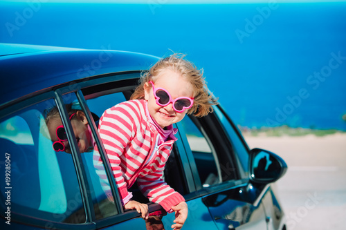 happy little girl enjoy travel by car at sea