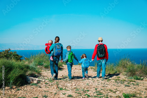family with three kids hiking travel in scenic nature
